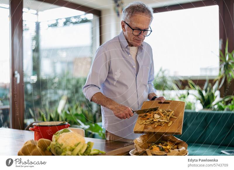 Mature man making compost from leftovers at home people caucasian grey hair casual day portrait indoors real people white people adult mature retired old