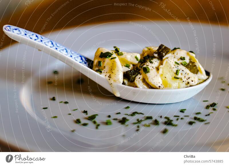 Rhenish potato salad on a tasting spoon with chives, cucumber and egg Cucumber and egg Sky Germany Potatoes Spoon Tasting dice Delicious Chives Egg Agriculture