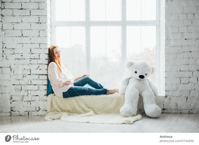 red-haired pregnant girl in light-colored blouse and blue jeans Bear pretty Birth Blouse Bright Child Day variety Family fpchallengediversity Girl hairstyle