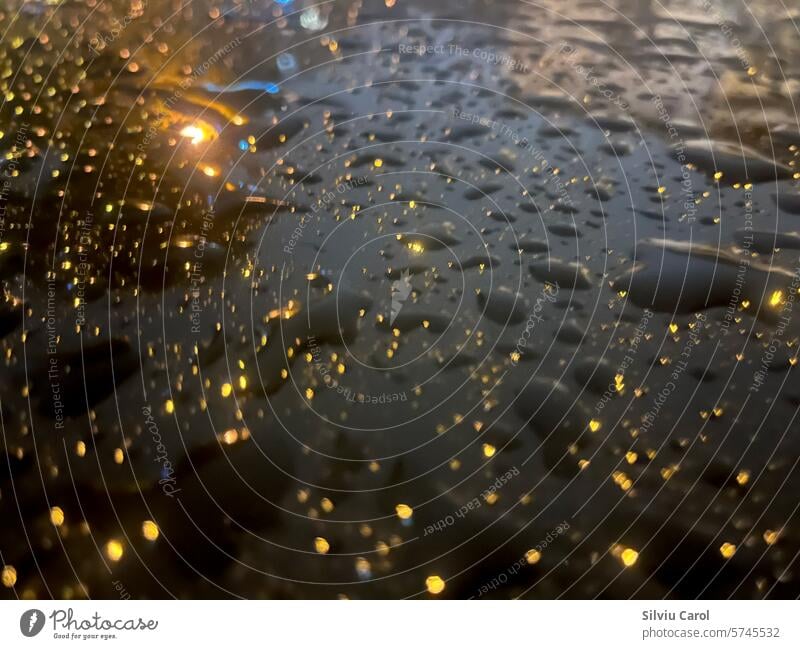 Closeup of water drops with light reflections on black surface dew pure condensation abstract cool droplet grunge rainwater clean texture nature pattern macro