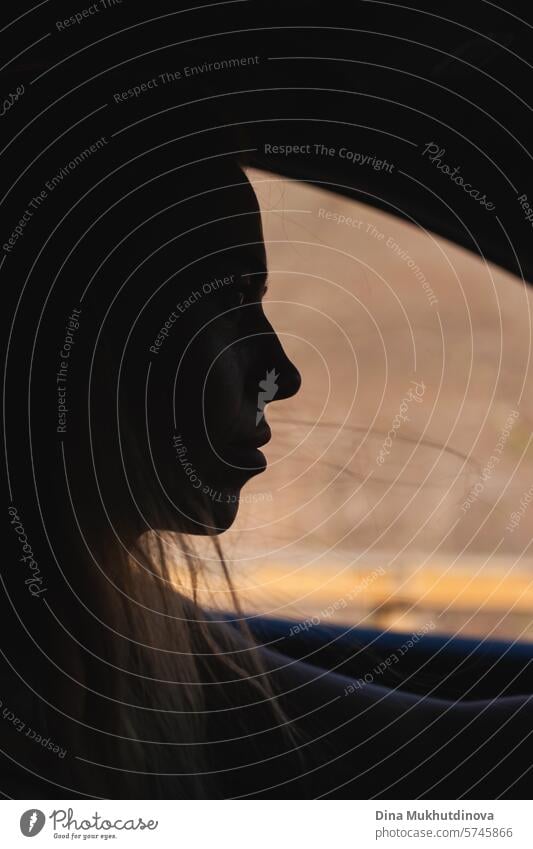 silhouette of woman driving in a car  through mountains closeup. Road trip and adventure. driver female road trip travel journey young transport vehicle freedom