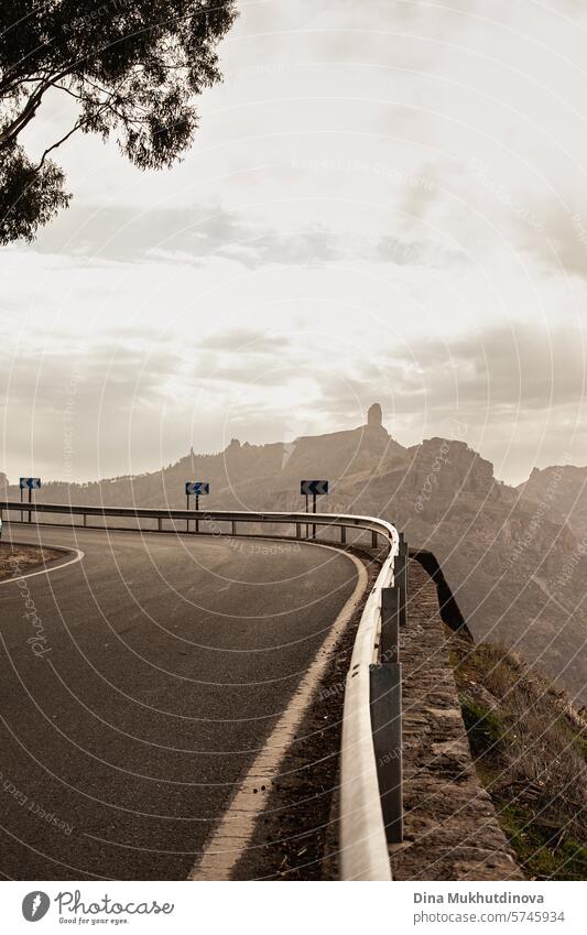 winding road in the mountains with a view over peaks of rocks and mountain in cloudy weather in Gran Canaria island gran canaria adventure road trip travel