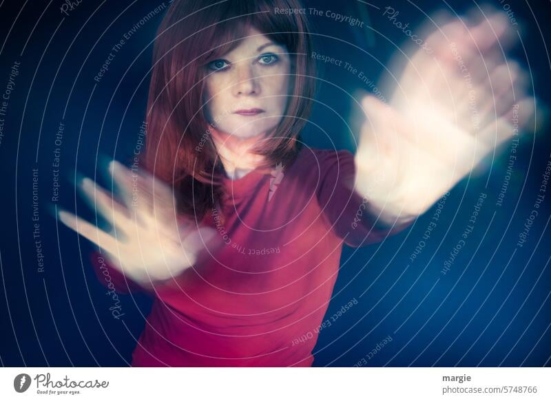 A determined woman in a defensive stance Woman portrait Resolve Looking Feminine Adults Long-haired Movement motion blur hands Protective defense Self-confident