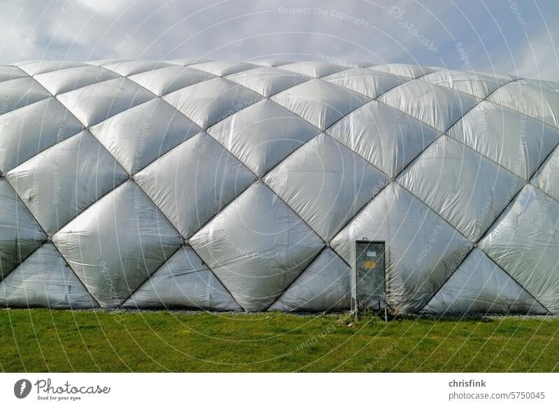Air dome with silver exterior foil stands on a green field air dome Gymnasium Sports Hall Sporting Complex Colour photo Leisure and hobbies Ball sports