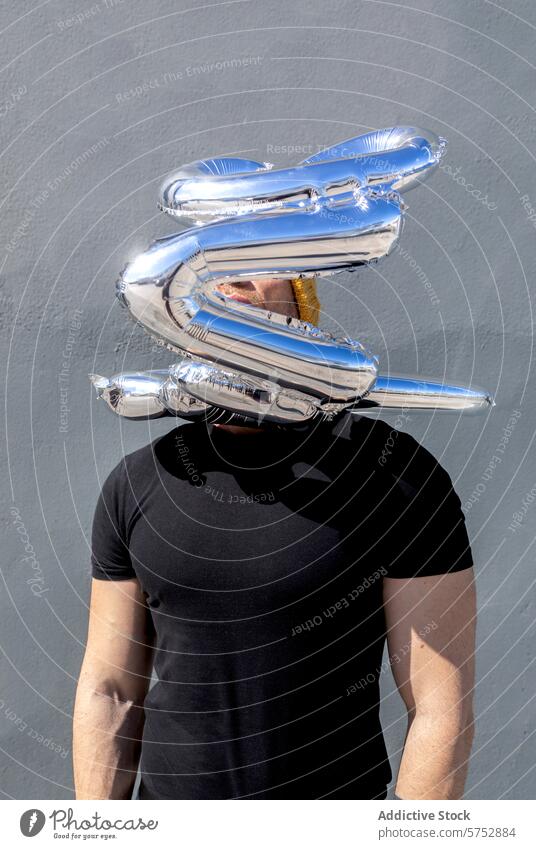 Anonymous man with silver love balloons over head romance concept hidden faceless emotion affection celebration relationship valentine feeling mystery