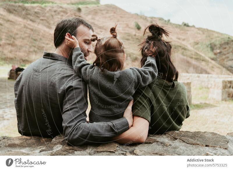 Loving family enjoying a moment outdoors together love embrace nature togetherness affection bonding cozy gravel casual relationship quality time contentment