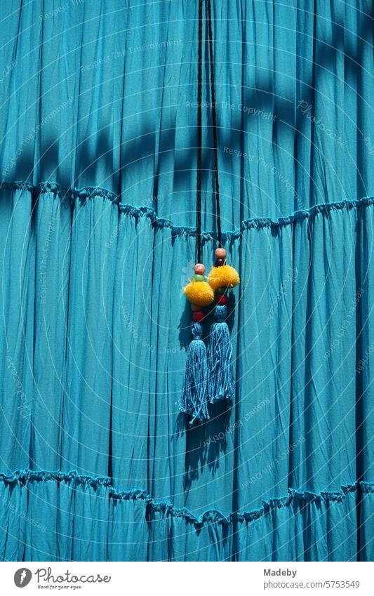 Elegant summer dress in blue with decoration in the bazaar on the historic Irgandi Bridge in summer sunshine in Bursa in the Uludag Mountains in Turkey Dress