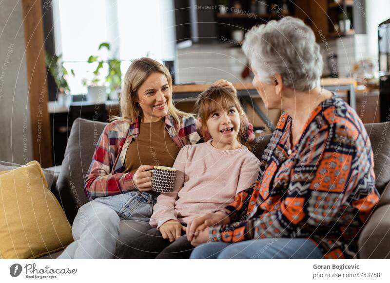 Generational bonding, grandmother, daughter, and grandchild sharing stories on a cozy afternoon casual clothing chatting comfort connection contentment