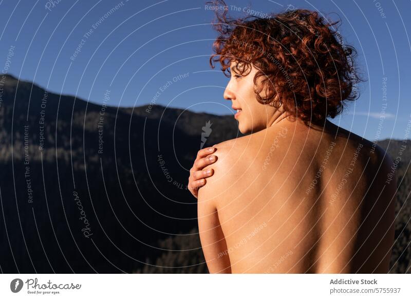 Serene dancer finding tranquility amidst mountains female back nature serene outdoor bare shoulder curly hair profile peaceful sunshine beauty natural light