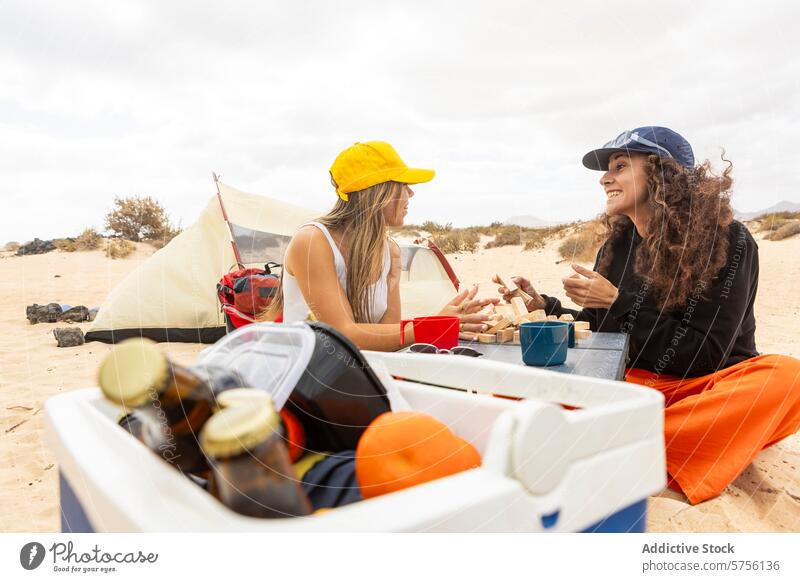 A happy couple engages in a playful game of Jenga at their beachside camp, sharing smiles and memories camping tent leisure vacation women happiness travel