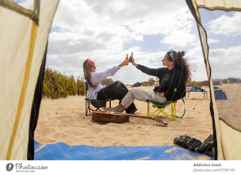 A couple toasts with bottles of beer, celebrating their affection while seated outside their tent at a scenic beach campsite camping love celebration chair