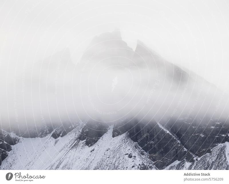 Icelandic Mountains Shrouded in Enigmatic Fog iceland mountain fog snow peak enigmatic white foggy mist landscape nature outdoor cold winter rugged terrain