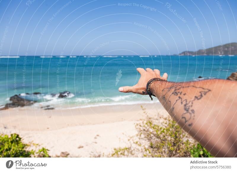 Pointing at the tropical coastline of Indonesia indonesia beach travel tattoo arm sea vacation sand water sky blue reach point nature scenic holiday outdoor