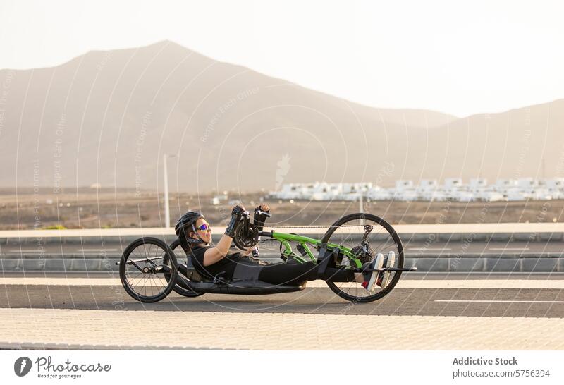 Determined handbike athlete training on scenic road mountain female adaptive sports determination paracycling competition fitness happy health endurance racing