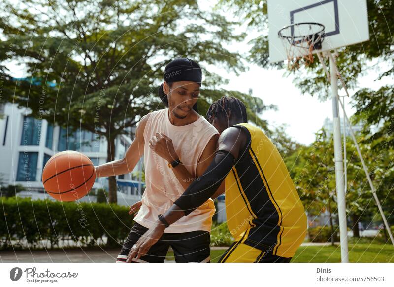 Black men playing streetball on outdoor court Basketball game friend defend attack Ball hit Sports sportsman athletes black man African American people paint