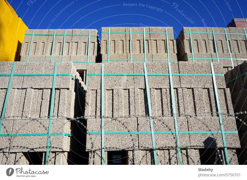 Stacked blocks of gray aerated concrete in the warehouse of a building materials store under blue skies and sunshine in Adapazari in the province of Sakarya in Turkey