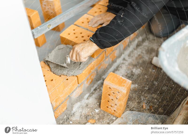Craftsman coating the brick wall with concrete and trowel Brick Concrete putty knife Coating Wall (building) job Measurement work Industry Hand Construction