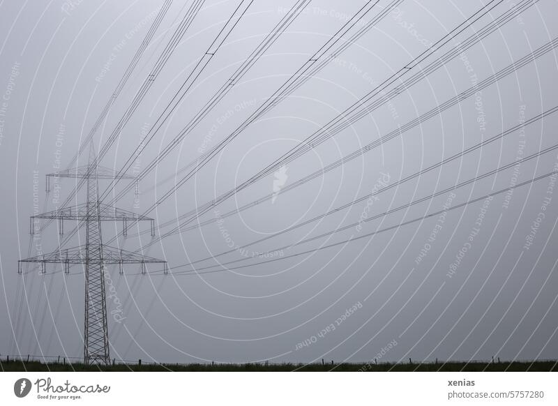Long lines: Electricity pylon in the fog stream Energy Transmission lines Cable Technology Energy industry high voltage Overhead line Power transmission