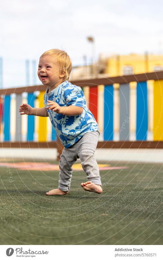 Joyful moment at the playground with family baby down syndrome playing joy toddler colorful happiness barefoot child kid outdoor recreation activity fun joyous