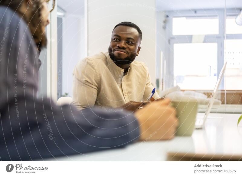 Collaborative Office Meeting Between Colleagues office meeting collaboration professional discussion colleague coworker black man pen holding engagement table