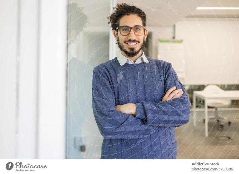 Confident Middle Eastern businessman smiling at camera middle eastern confident looking at camera office professional corporate arms crossed warm smile bright
