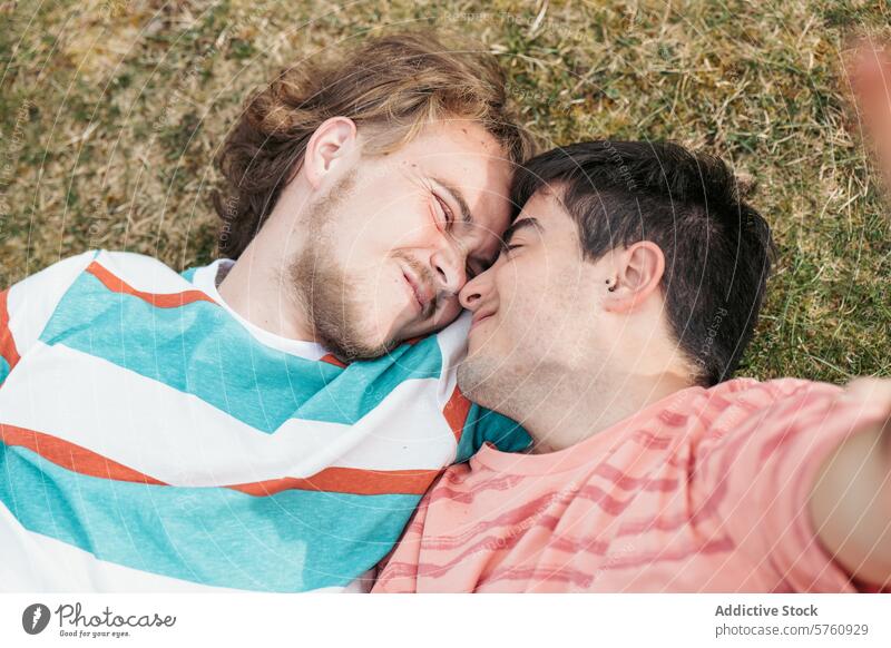 Capturing an intimate close-up of a gay couple, both transgender, in a serene moment, nose to nose, eyes closed, savoring togetherness tenderness grass
