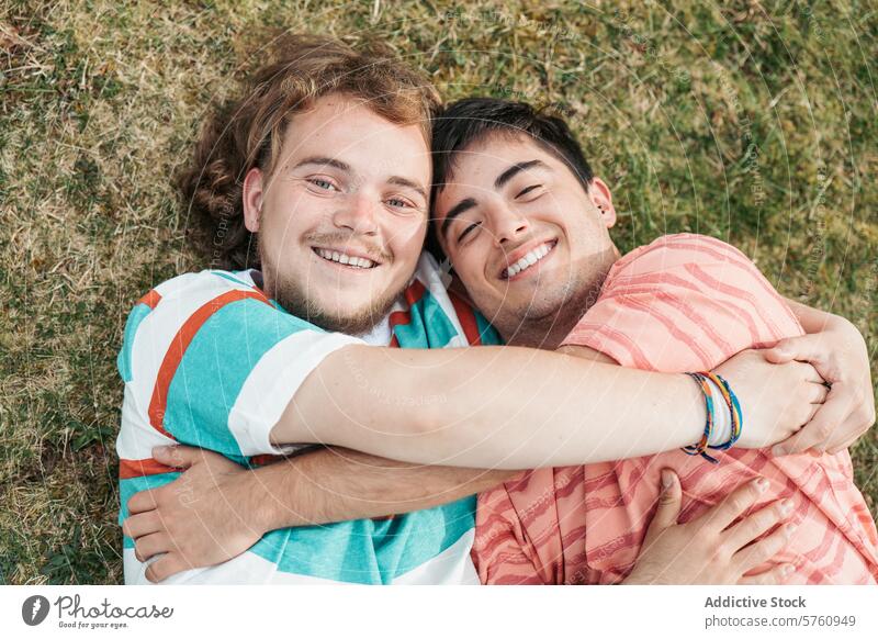 A heartwarming embrace between two gay men, both transgender, as they laugh and enjoy a close moment together on the grass love happy laughter smile couple