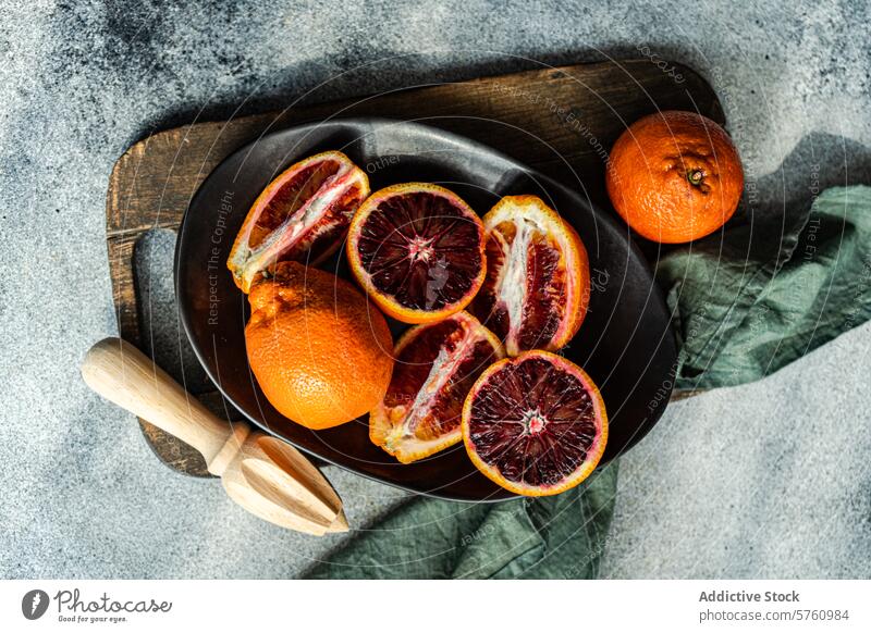Fresh blood oranges sliced on a dark kitchen plate fruit citrus cut juicy fresh dark plate wooden board rustic food top view healthy vitamin c ripe garnish