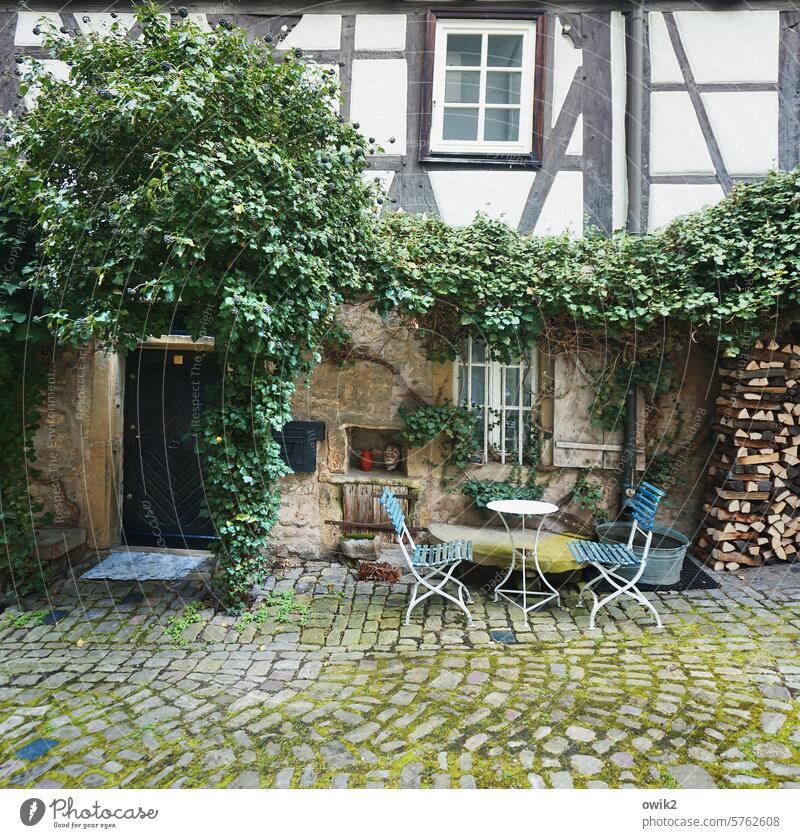 Backyard cafe Café Spartan chairs Table Simple Appealing House (Residential Structure) Old Historic Half-timbered house Building Facade Exterior shot Old town