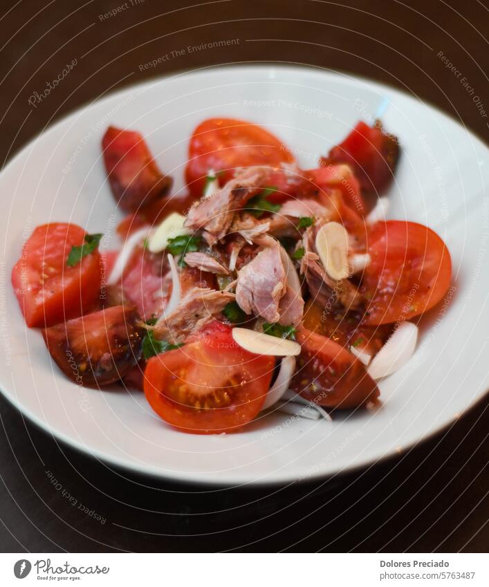 Tomato and tuna salad, with onion. Gourmet dish with quality tomatoes. gourmet nutrient olive oil traditional recipe summer parsley italian health olives lunch