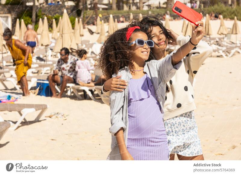 Young girls enjoying a beach day with a selfie friends children kid female summer vacation fun holiday leisure coast sand sea sunlight daytime casual clothing