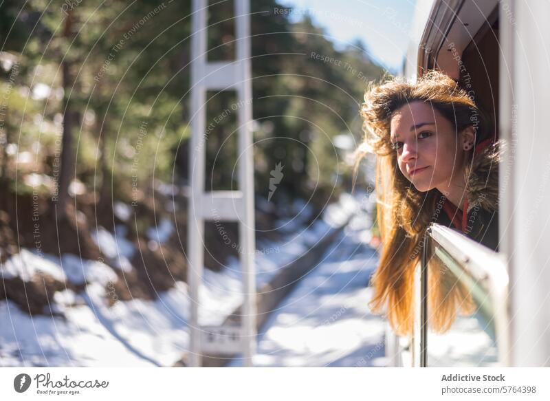 Woman gazing out of train window in winter woman view sunny day travel journey passenger transportation nature snowy forest youth enjoyment outdoors adventure