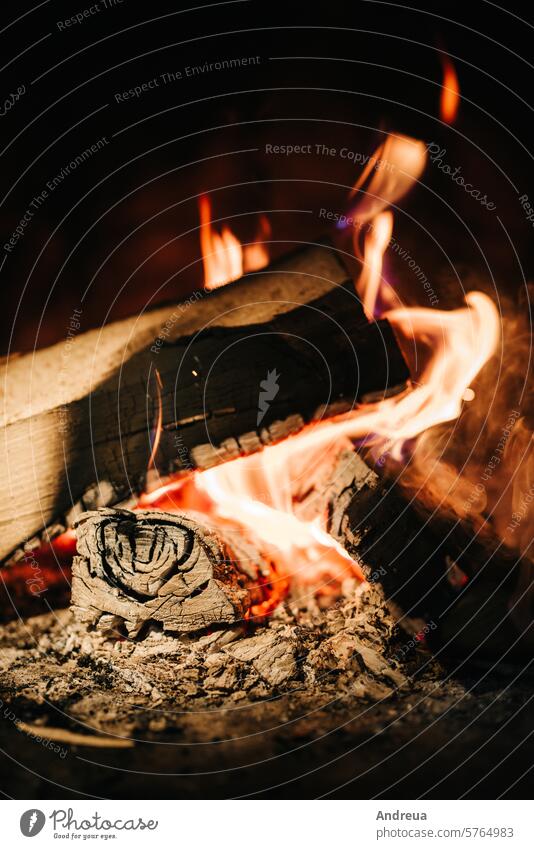 burning smoldering fire in a stone fireplace wood heat ashes flame orange firewood stove campfire vent coziness inside at home bask