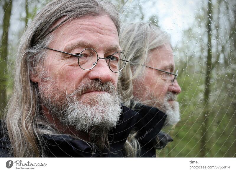 Double strategist Man portrait Eyeglasses Long-haired Beard Forest Skeptical Earnest Looking into the camera Jacket Cold raindrops two Reflection