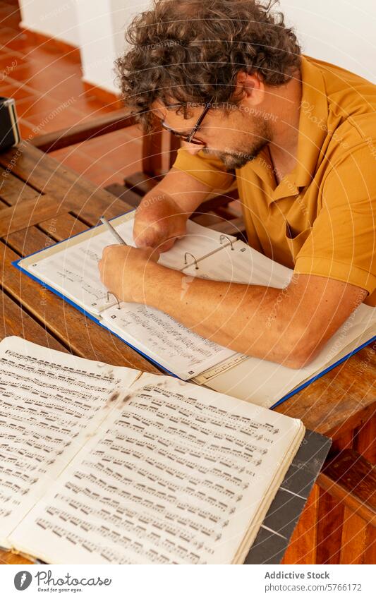 One-armed trumpeter composing music at home one-armed courtyard male man creative process tranquility intense engagement composition sheet score pencil wooden