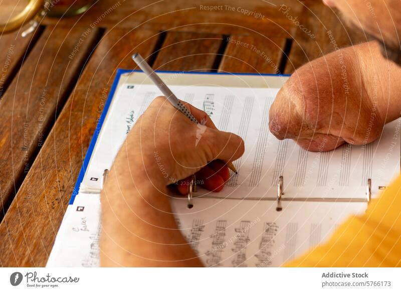 One-armed trumpeter composing music at home one-armed courtyard male man inspiration creativity composition dedication sheet music pen notes process