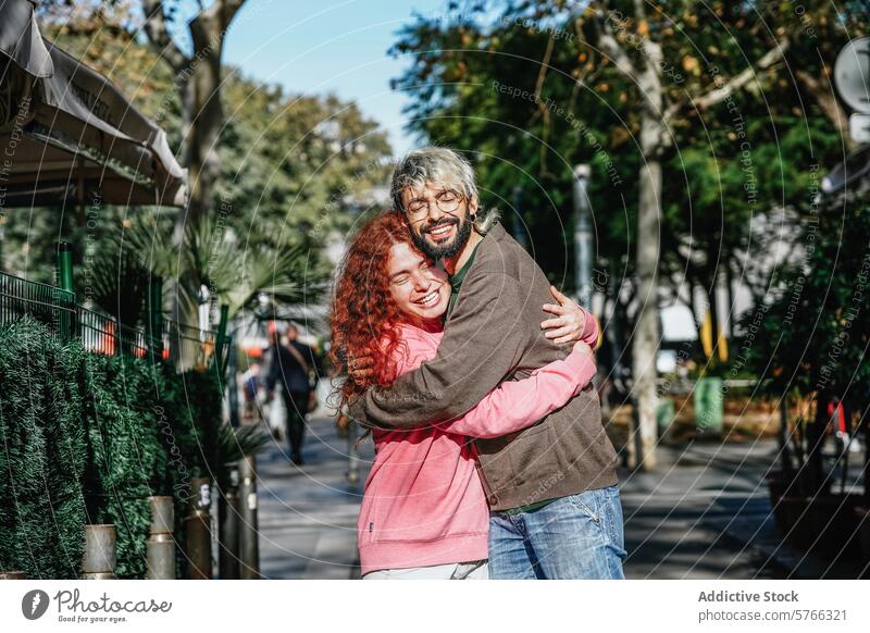 A joyful couple shares a heartfelt hug on a city sidewalk, surrounded by greenery and the bustle of urban life happy embrace casual clothing love affection