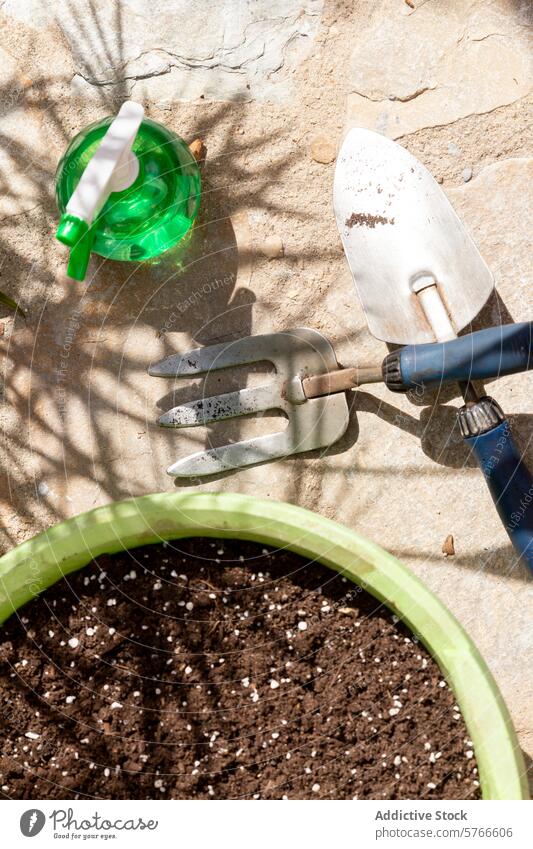 Gardening essentials on patio ready for planting gardening tools watering can spade hand fork pot soil outdoor hobby agriculture cultivation ground equipment