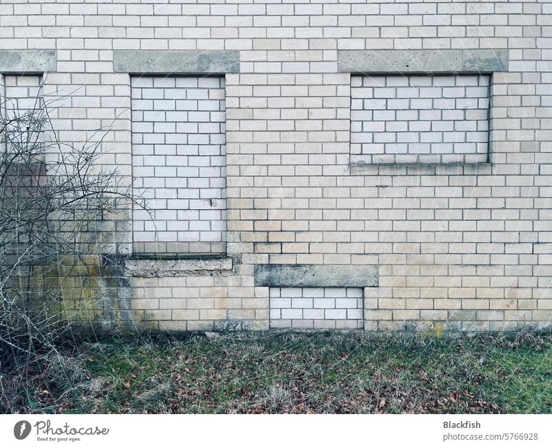 House facade with bricked-up windows Architecture Gray Exterior shot Deserted Subdued colour Colour photo Facade Window Sharp-edged Day