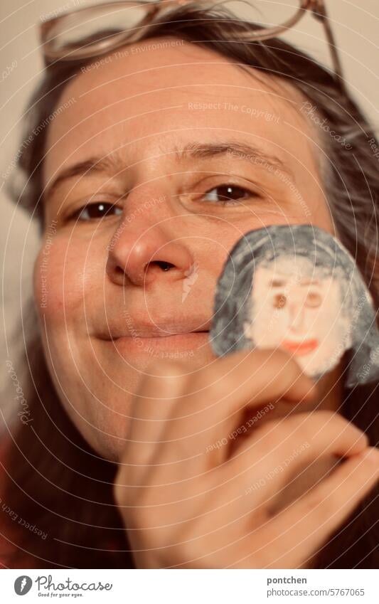 alter ego. a smiling woman holds a female face made of salt dough next to her own face Woman Smiling Face compromise Alter ego Equal Creativity Handicraft
