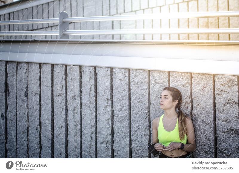 fit happy woman resting after do sport , running and workout fitness stretching exercise young training healthy listening music outdoor beautiful lifestyle park
