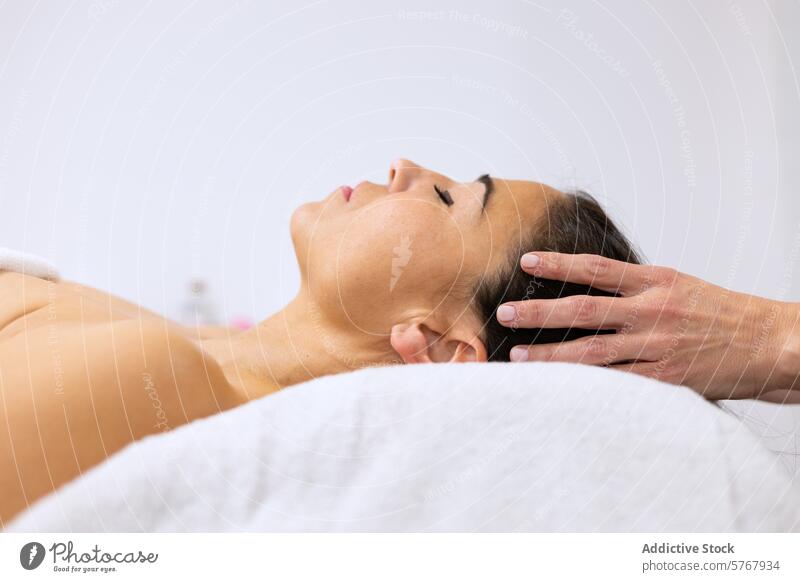 Woman receiving relaxing head massage at spa adult alternative medicine beauty body care bodycare craniofacial enjoyment eyes closed face hand headshot healing