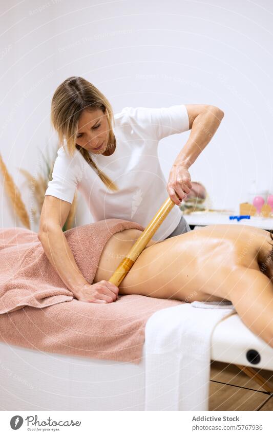 Masseuse doing a relaxing massage with wood therapy technique adult anti anti-cellulite beauty body body care body part bodycare circulation client copy space