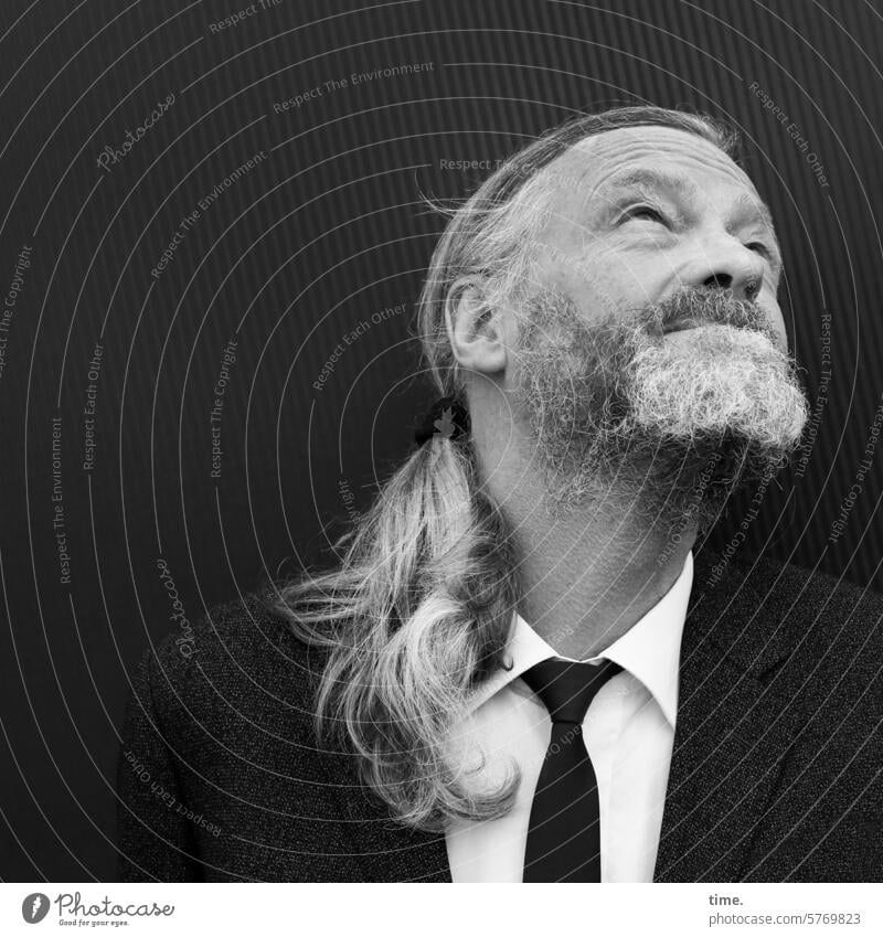 View into the sky Man Suit Gray-haired portrait Long-haired Braids Stylish Tie Half-profile Upward stylish Observe search Beard Wall (building) Wall (barrier)