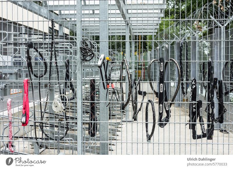 Various bicycle locks on a security fence of a bicycle parking area Bicycle Safety Theft Protection anti-theft protection