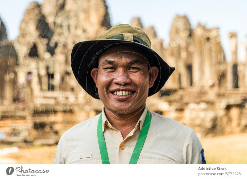 Friendly guide smiling in front of Angkor Wat temple angkor wat cambodia siem reap male tourism smile man travel culture hindu landmark heritage happy asian hat