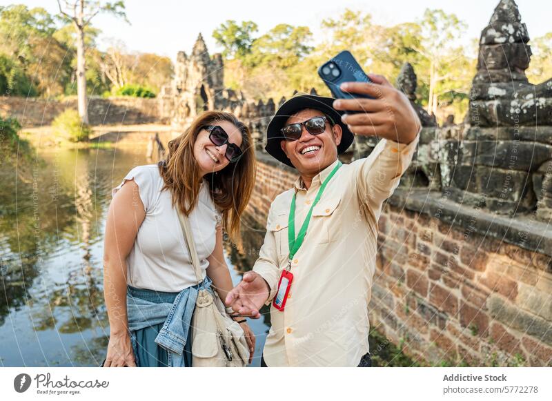 Tourists taking a selfie at Angkor Wat temple, Cambodia tourist smartphone angkor wat siem reap cambodia historical travel photography vacation culture heritage