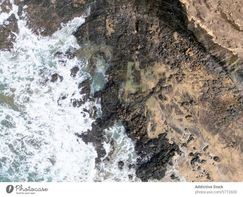 Aerial view of rugged coastline in Fuerteventura aerial view fuerteventura cofete beach costa calma texture rocky waves frothy sea ocean contrast nature remote