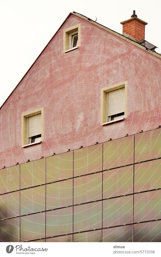 Old pink gable front of a residential building with windows and photovoltaic panels photovoltaics photovoltaic system pediment Apartment Building Window