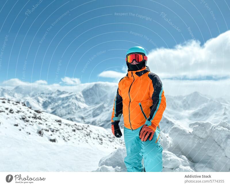 Adventurous mountaineer in snowy alpine landscape athlete winter sport adventure outdoor gear male summit peak ski snowboard helmet goggles jacket cold nature